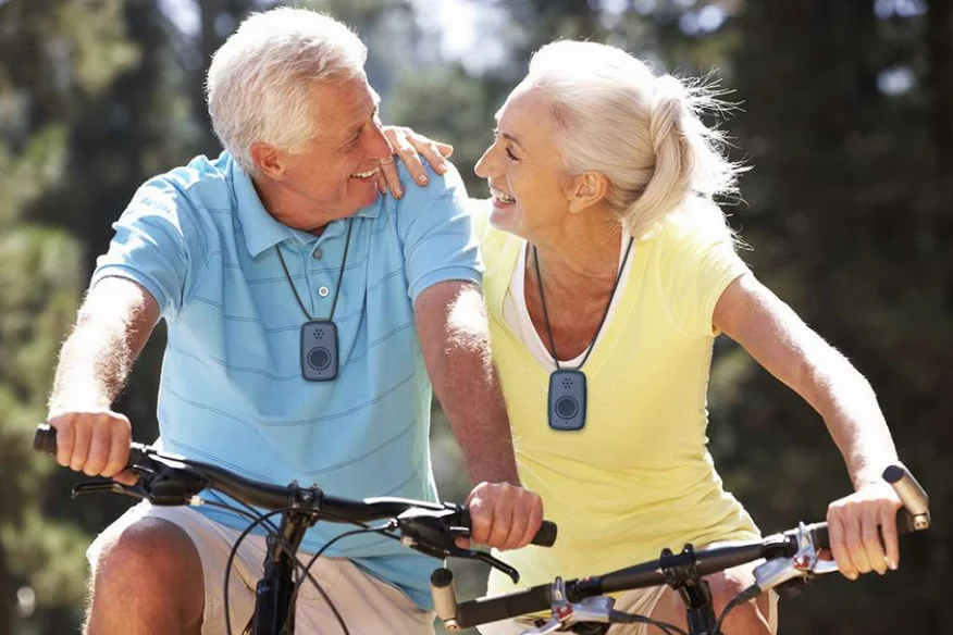 A married couple on bike wearing medical alert devices